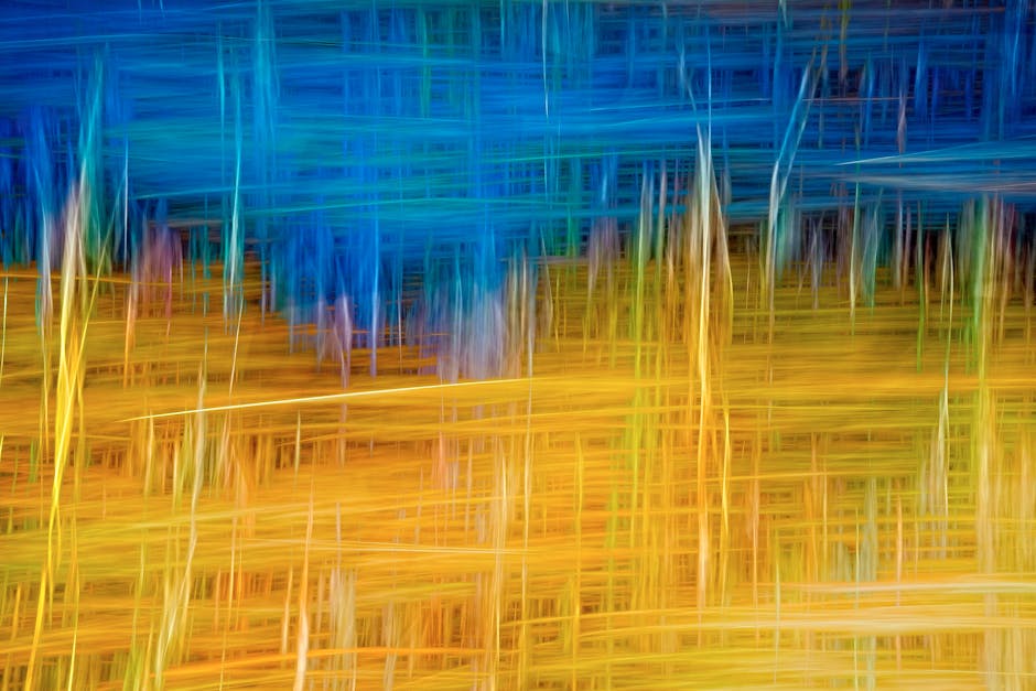 Dynamic abstract artwork featuring vibrant blues and golds, creating a sense of movement.
