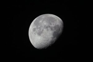 Detailed view of the waning gibbous moon set against a dark night sky.