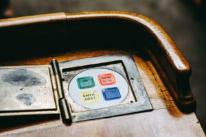 Wooden voting panel with multilingual buttons in Bern's Parliament, Switzerland.