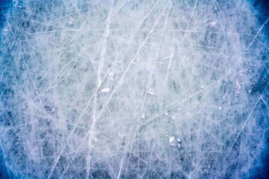 A textured, frosted ice surface with cracks, capturing the essence of winter cold.