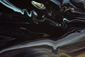 Explore the fluid dynamics of dark-toned abstract art with swirling patterns and depth.